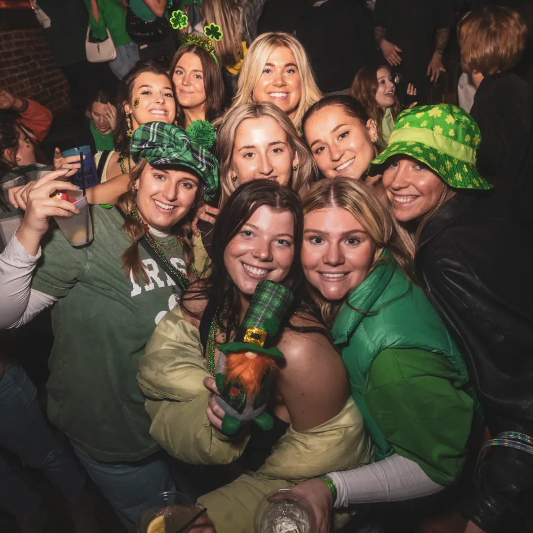 group of friends dressed in green for st patricks day bar crawl
